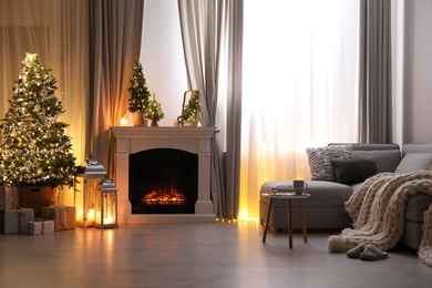 Photo of Stylish living room interior with beautiful fireplace, Christmas tree