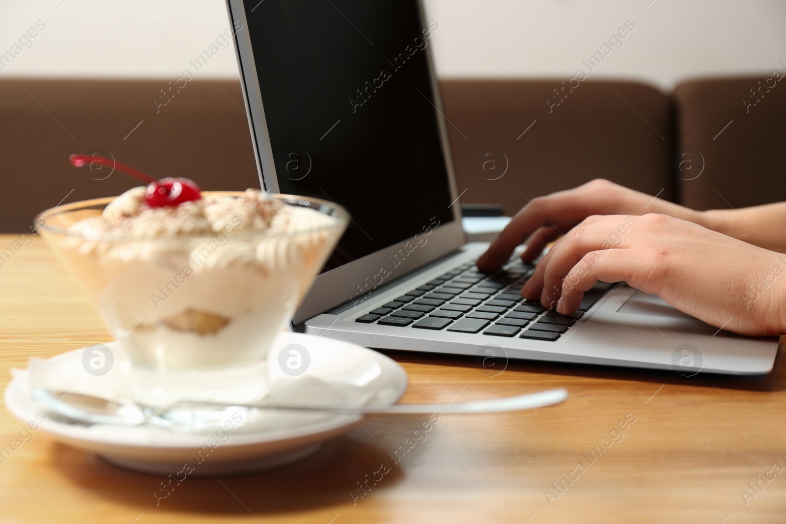 Photo of Blogger working with laptop in cafe, closeup