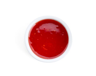 Photo of Spicy chili sauce in bowl isolated on white, top view