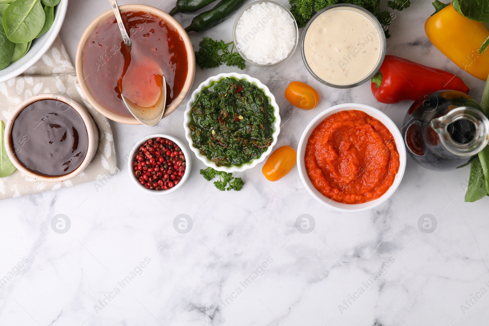 Photo of Different marinades and products on white marble table, flat lay. Space for text