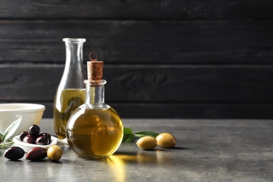 Composition with fresh olive oil on table