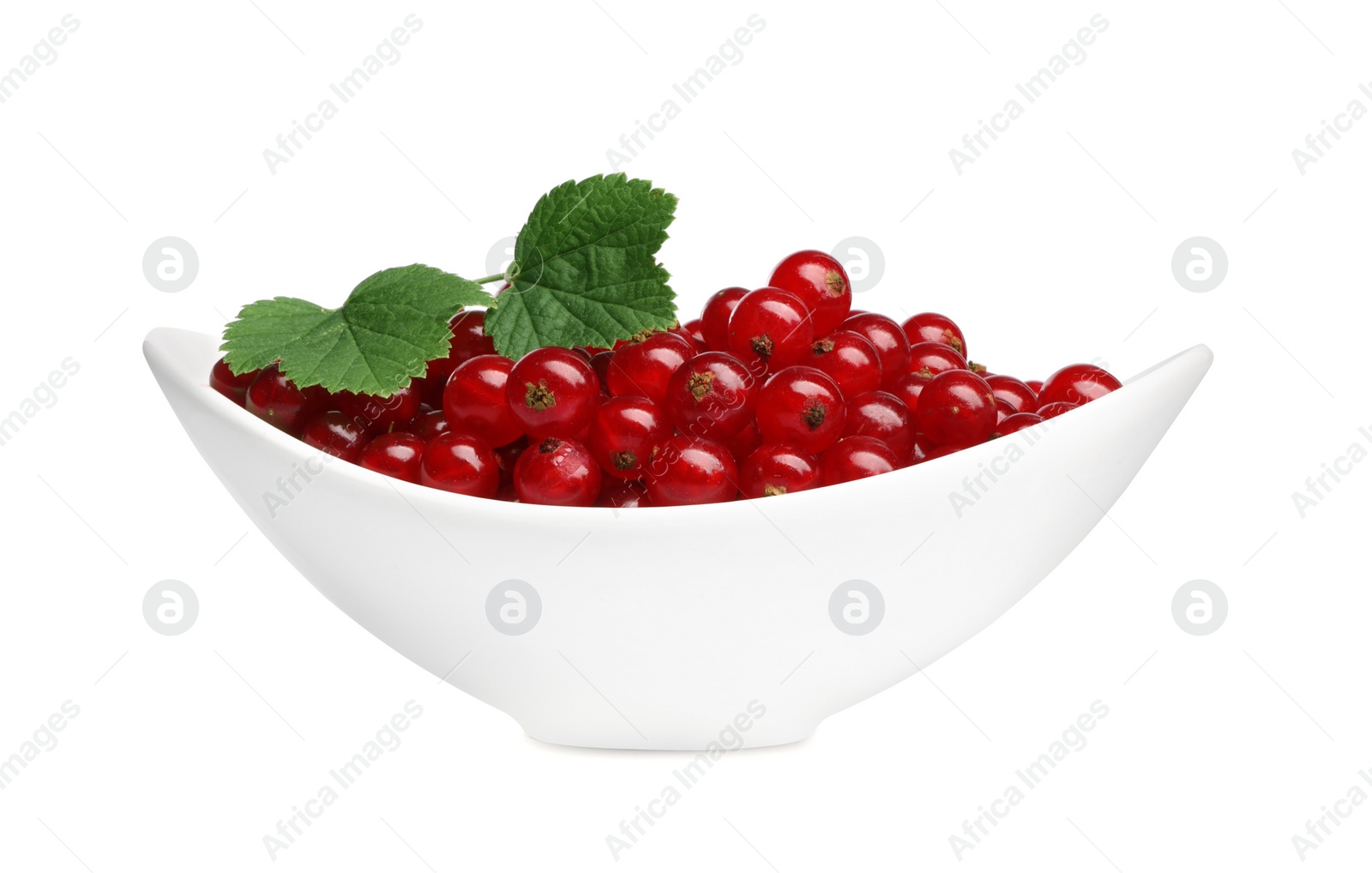 Photo of Many tasty fresh redcurrants and green leaves in bowl isolated on white