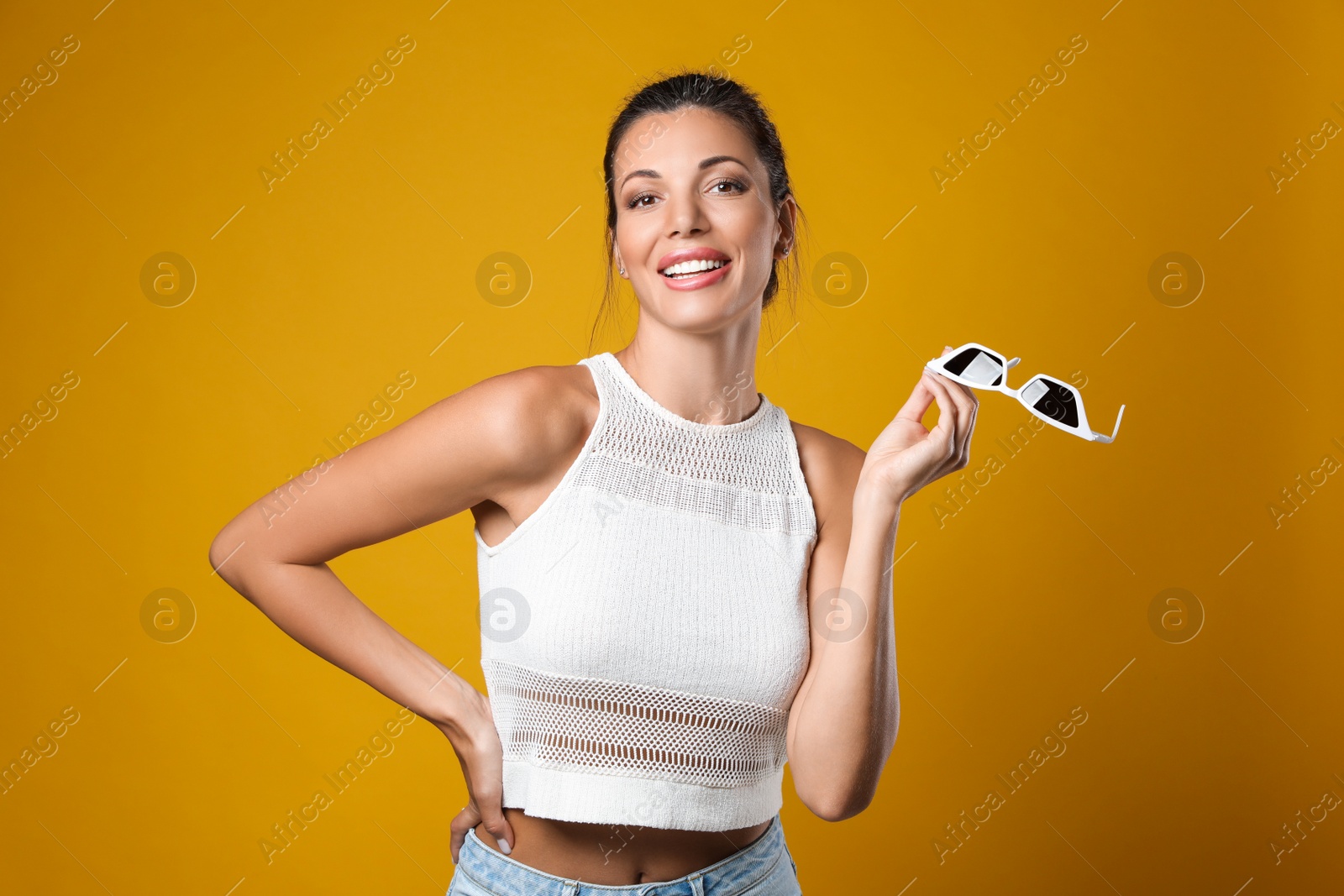 Photo of Beautiful woman with sunglasses on yellow background