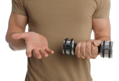 Photo of Sporty man with dumbbell suffering from calluses on hands against white background, closeup