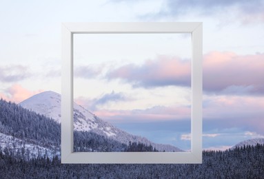 Wooden frame and beautiful mountains covered with snow in winter