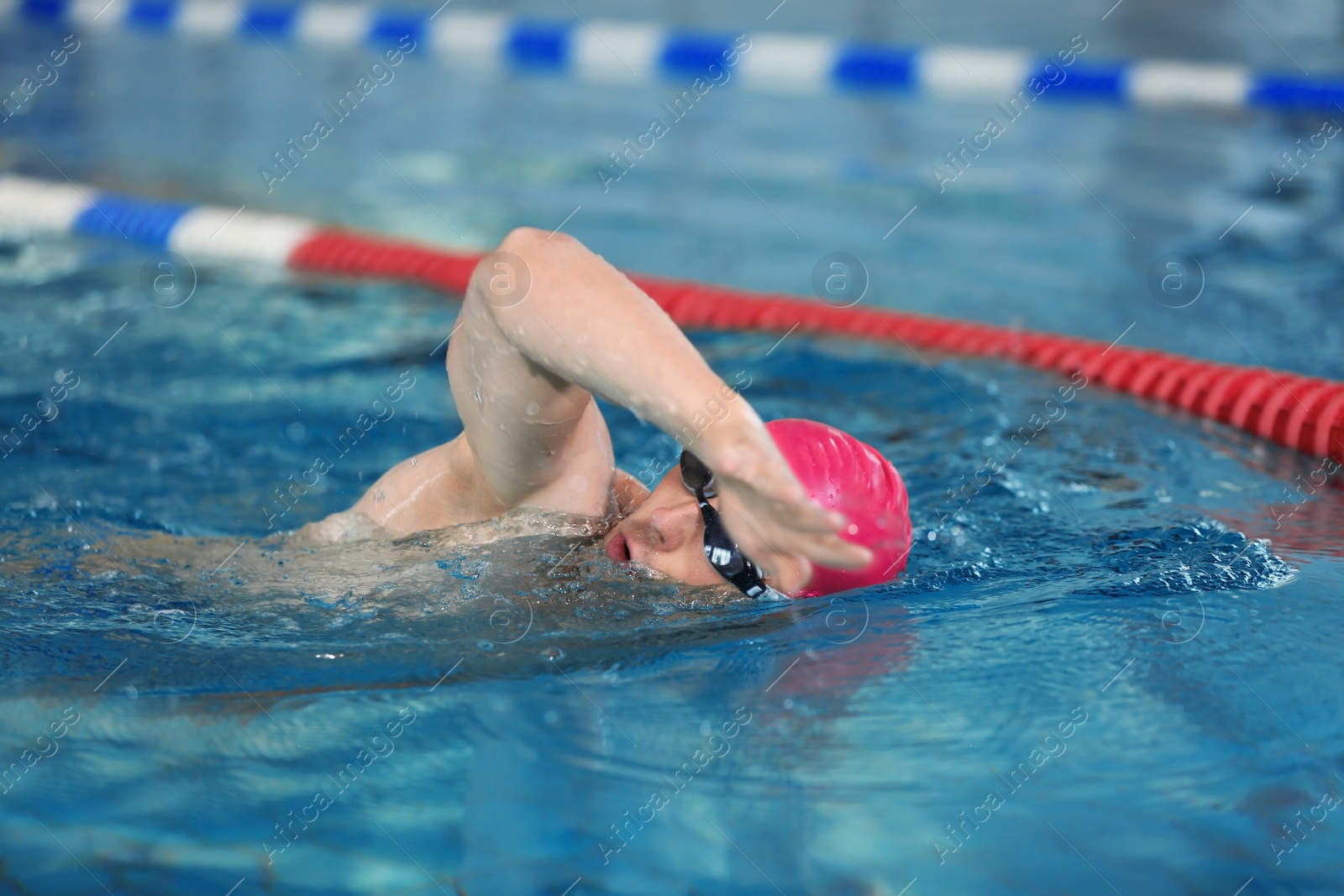 Photo of Young athletic man swimming in pool