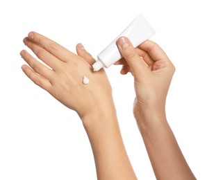 Woman applying cream on her hand against white background, closeup