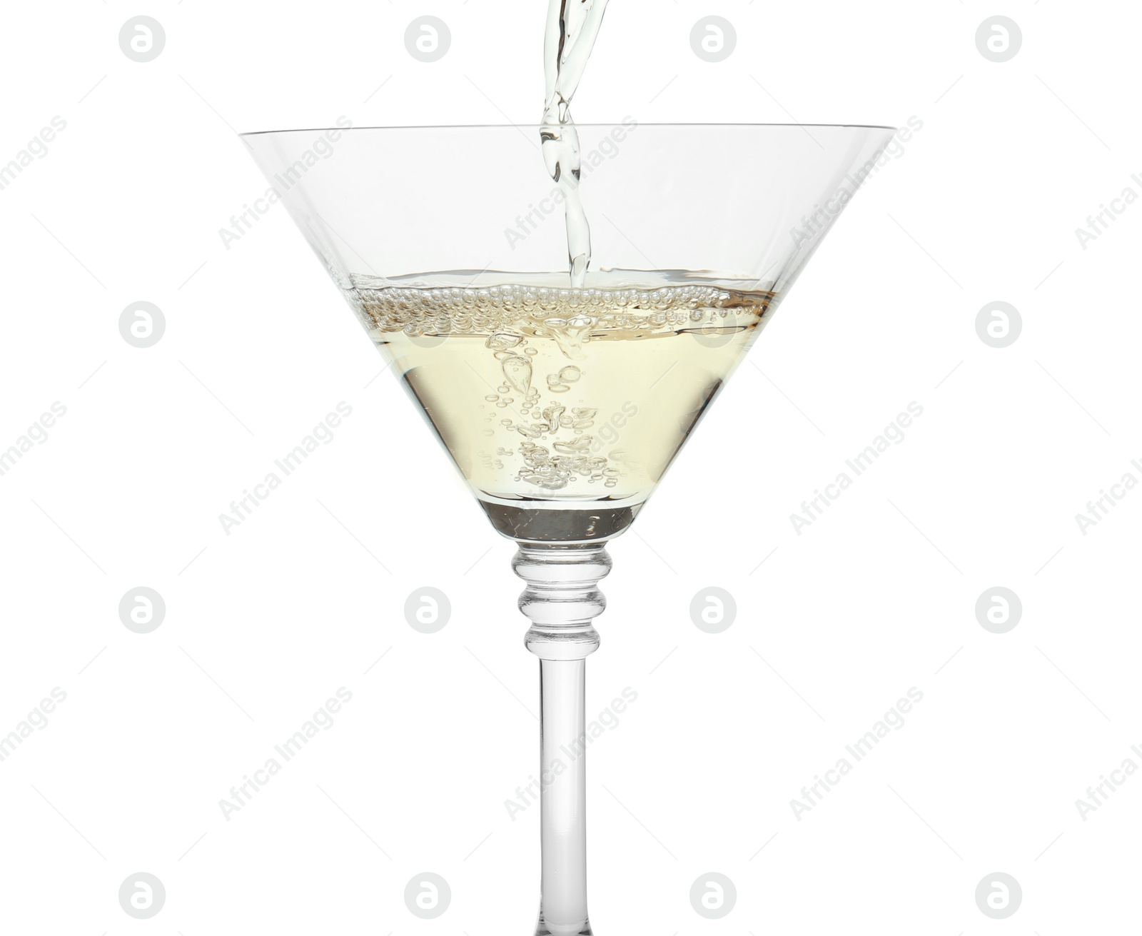 Photo of Pouring martini from bottle into glass on white background