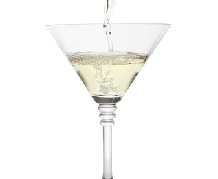 Pouring martini from bottle into glass on white background