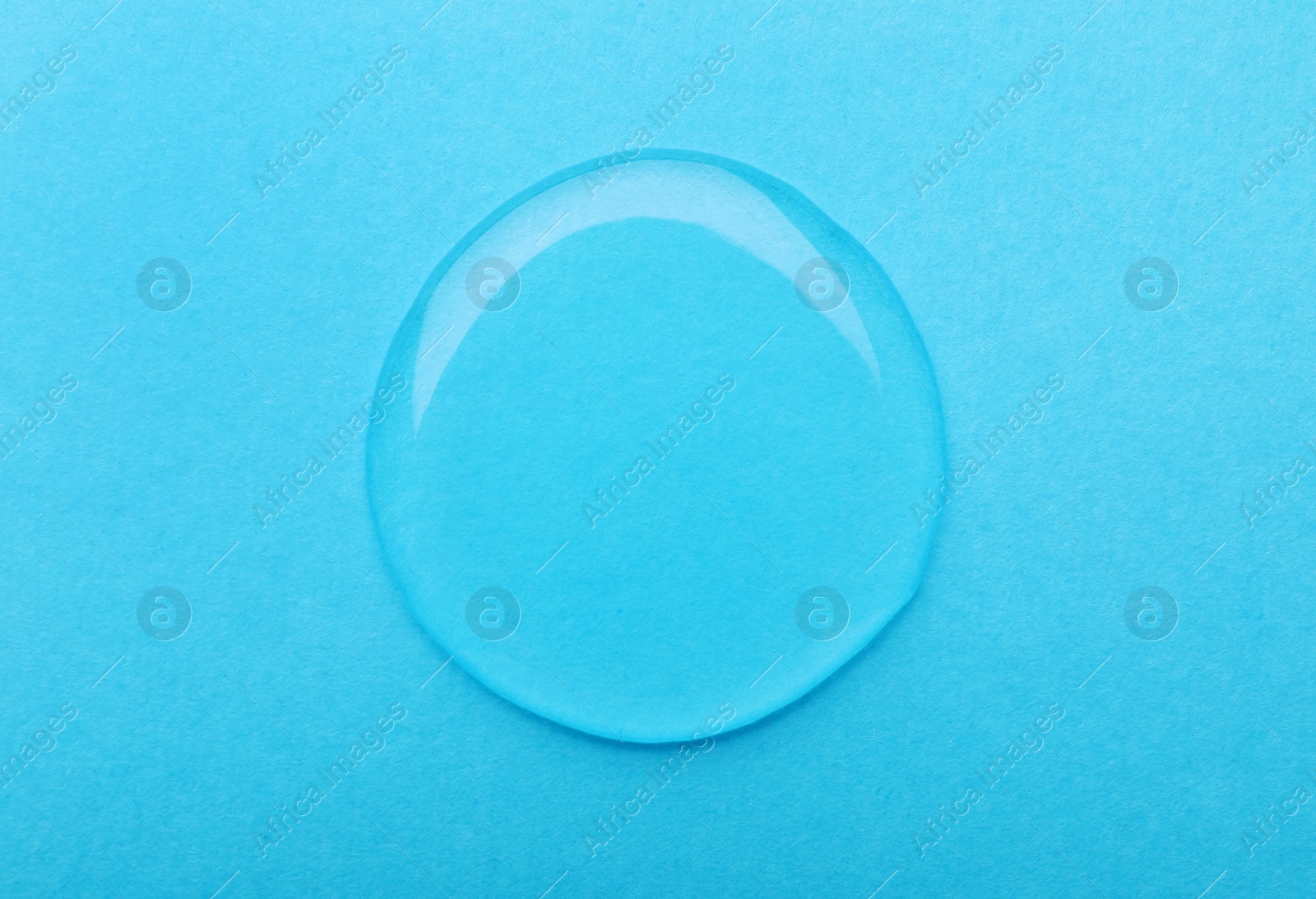 Photo of Drop on light blue background, top view. Save water concept