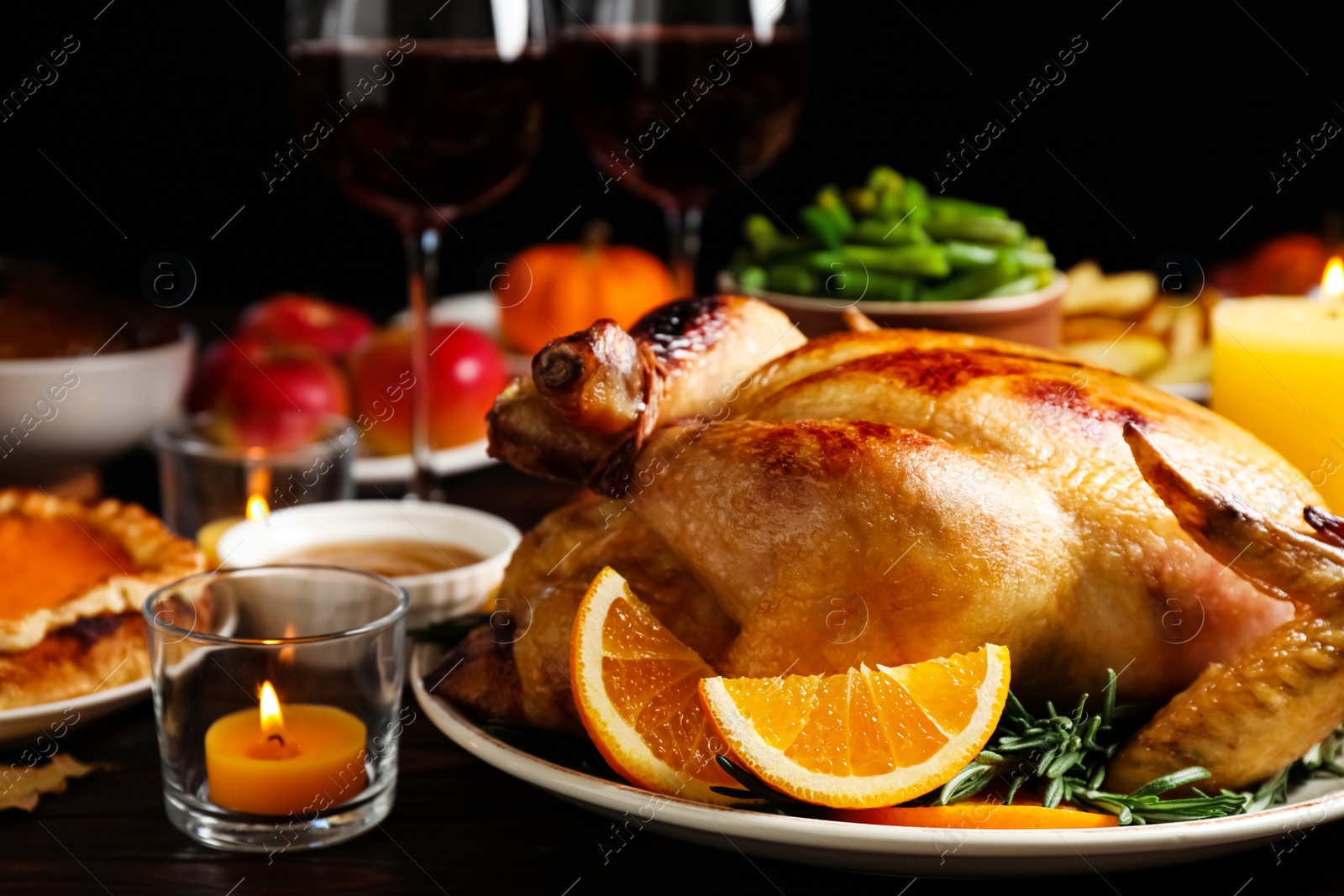 Photo of Traditional Thanksgiving day feast with delicious cooked turkey and other seasonal dishes served on table, closeup