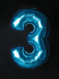 Photo of Blue number three balloon on black background