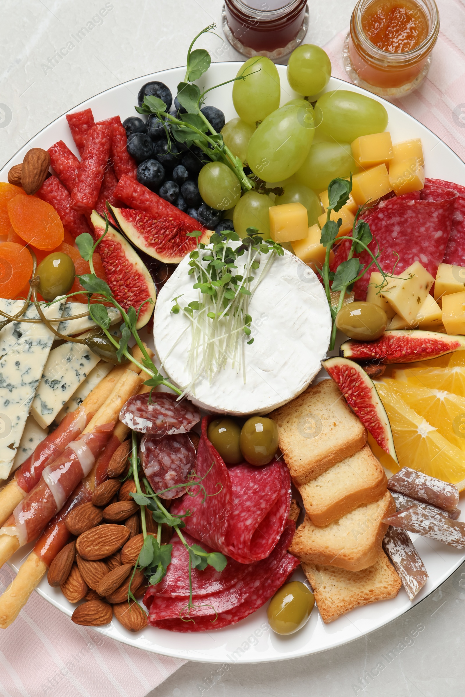 Photo of Set of different delicious appetizers served on light grey table, flat lay