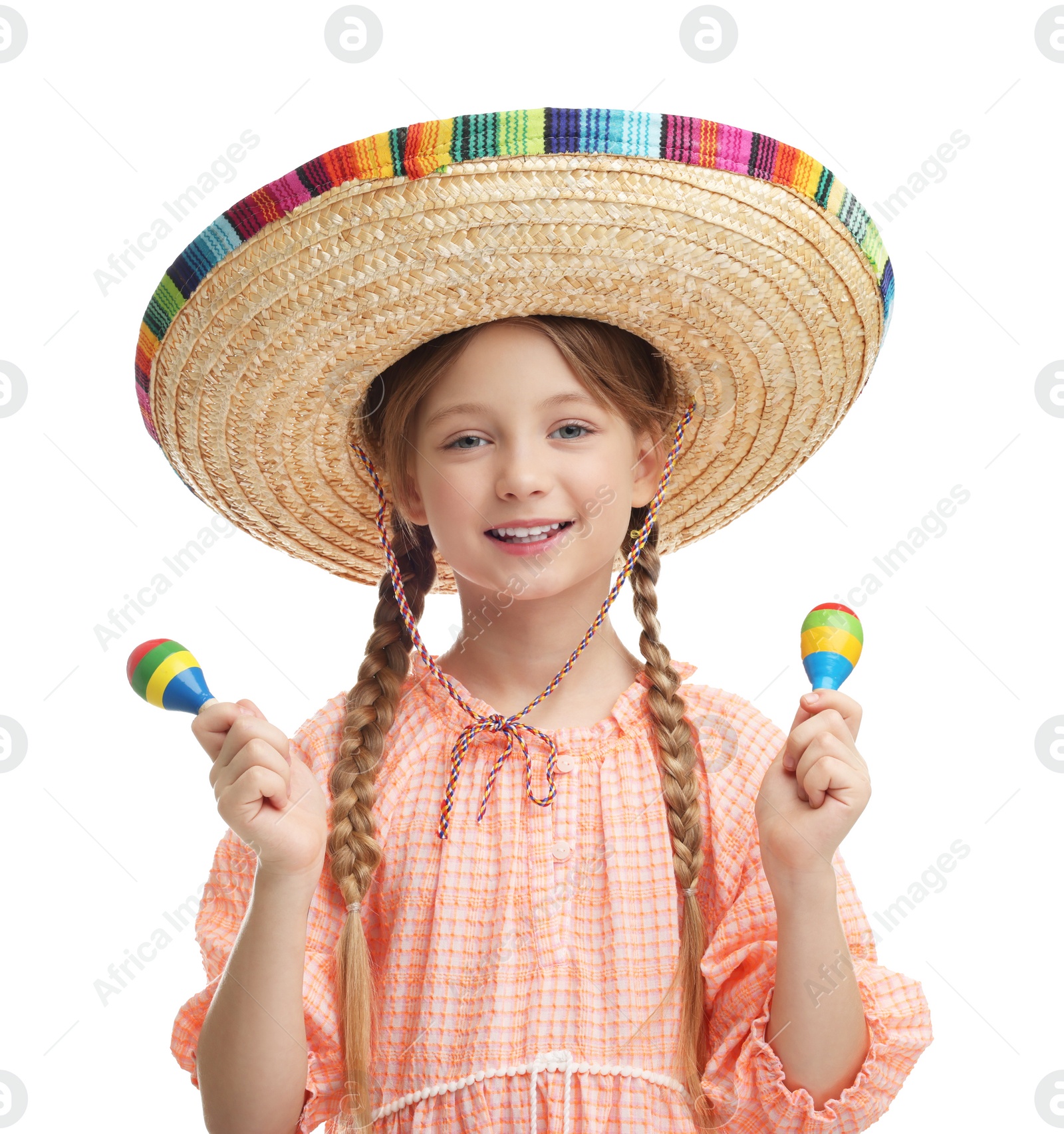 Photo of Cute girl in Mexican sombrero hat with maracas on white background