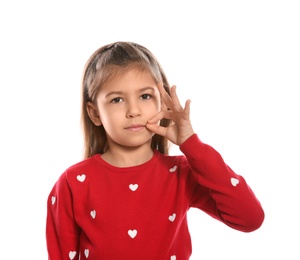 Little girl zipping her mouth on white background. Using sign language