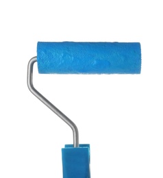 Photo of Roller brush with blue paint on white background