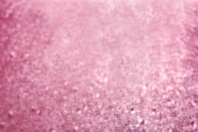 Photo of Blurred view of shiny rose gold surface as background