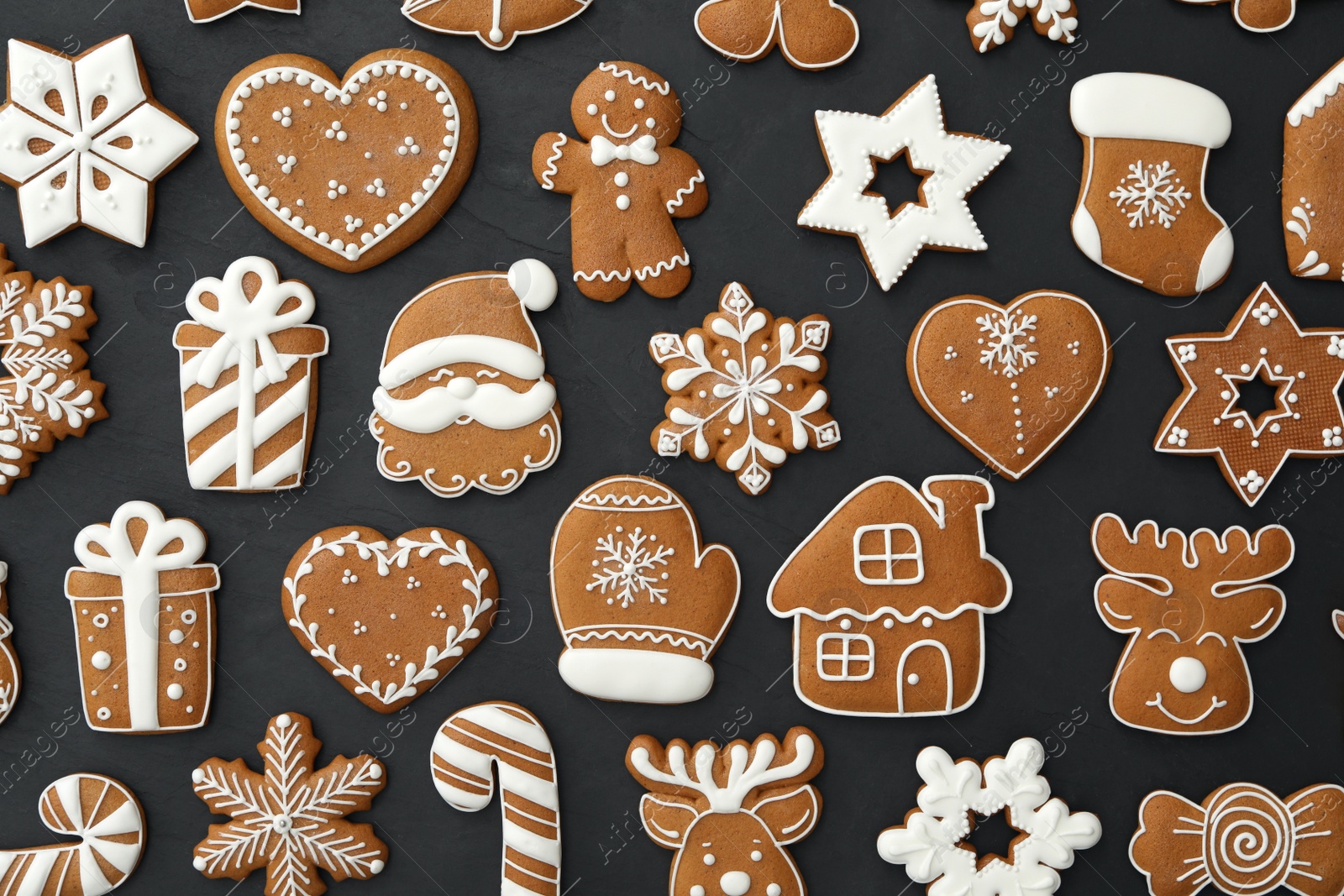 Photo of Many different delicious Christmas cookies on black table, flat lay