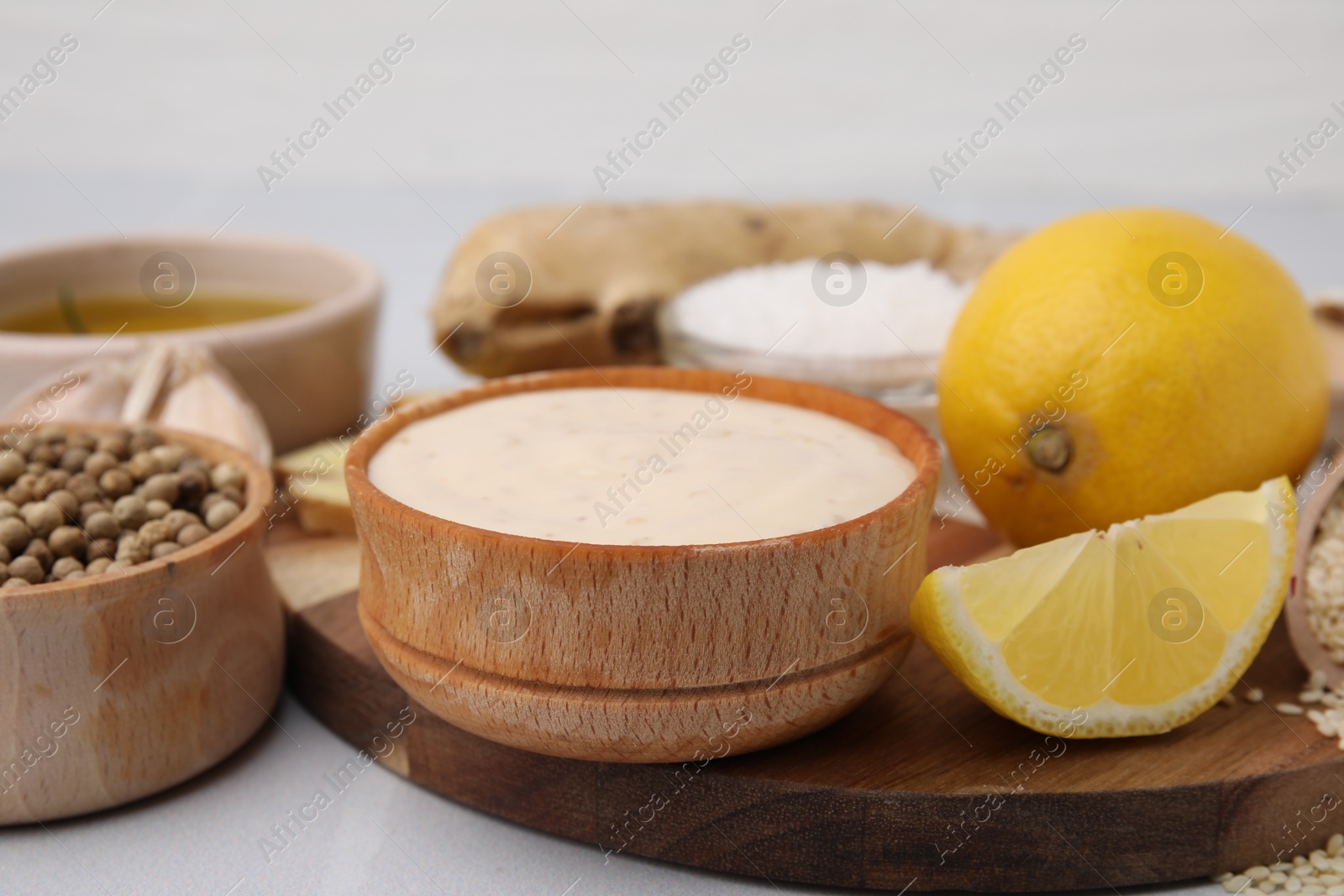 Photo of Fresh marinade and different ingredients on white table, closeup