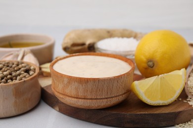 Fresh marinade and different ingredients on white table, closeup