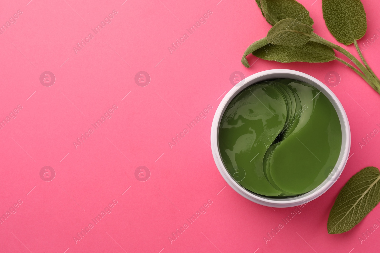 Photo of Jar of under eye patches and sage leaves on pink background, flat lay with space for text. Cosmetic product