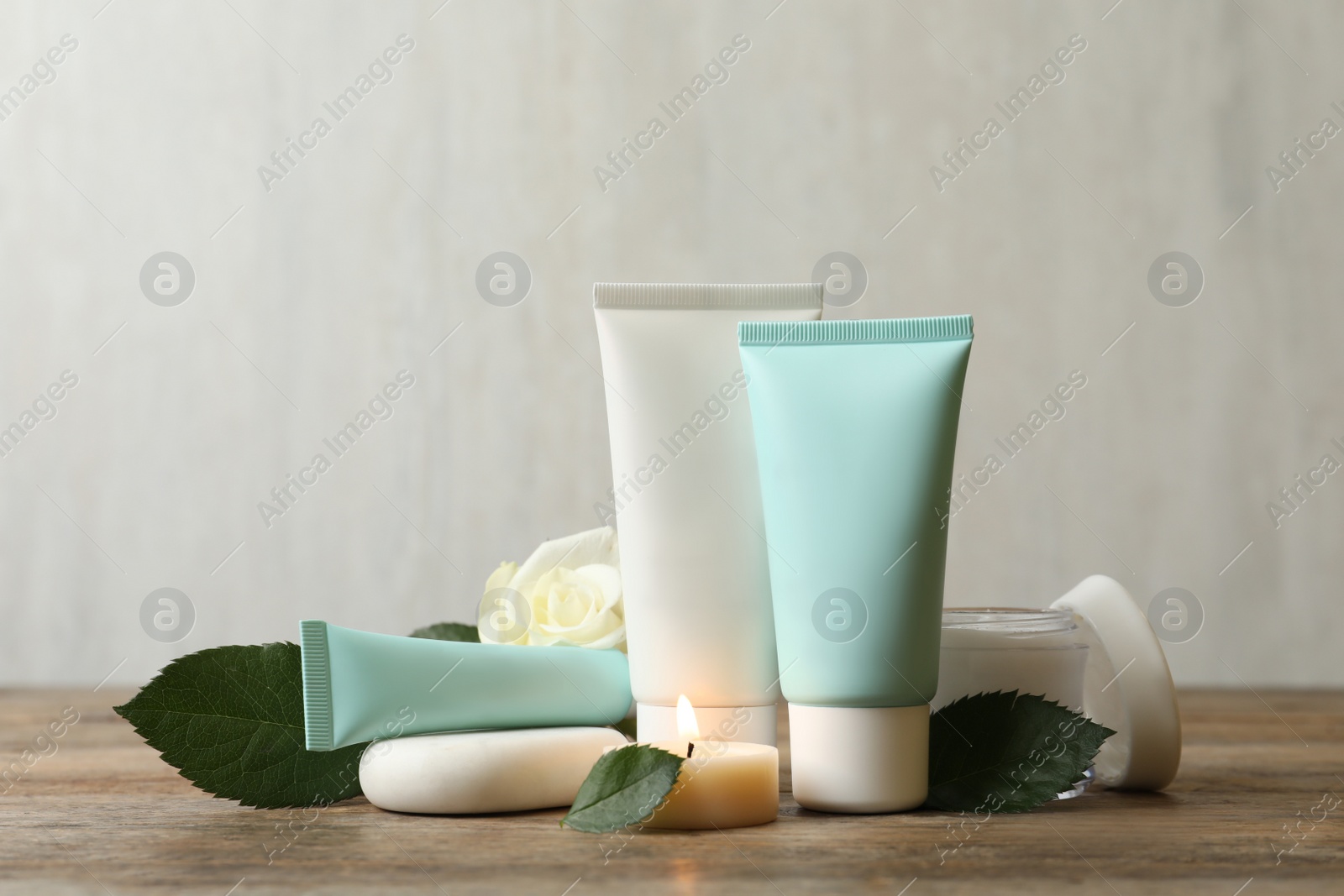 Photo of Composition with cosmetic products on wooden table