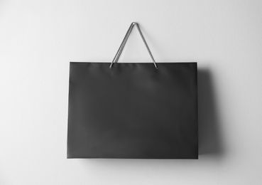Photo of Paper shopping bag hanging on white wall
