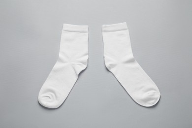 Pair of white socks on light grey background, flat lay