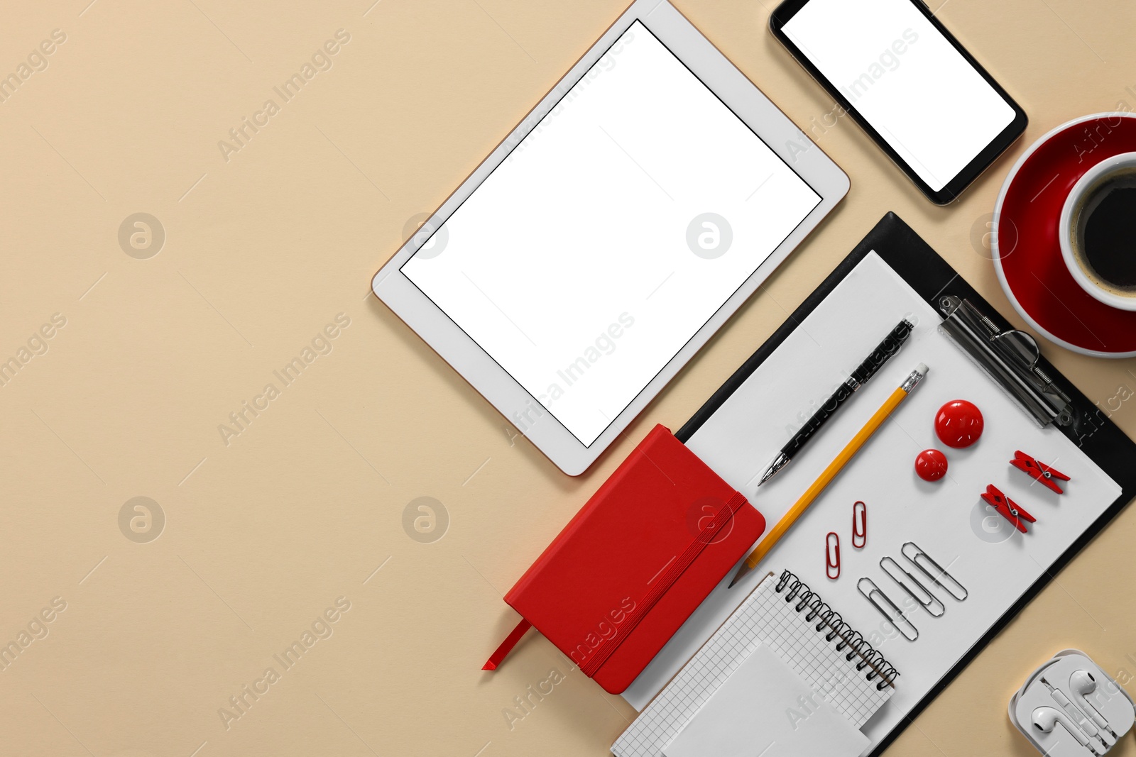 Photo of Modern tablet, smartphone, stationery and coffee on beige background, flat lay. Space for text