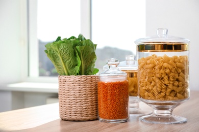 Products in modern kitchen glass containers on wooden table