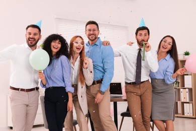 Photo of Coworkers having fun during office party indoors