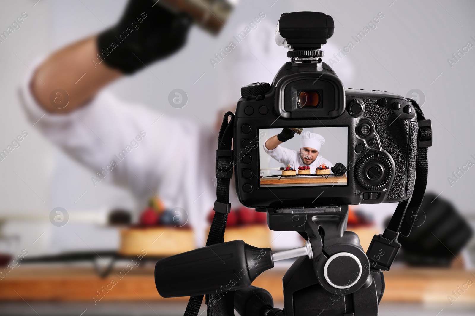 Image of Food photography. Shooting of chef decorating desserts, focus on camera