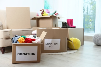Photo of Carton boxes with donations in living room