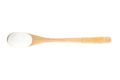 Photo of Wooden spoon with tasty organic yogurt isolated on white, top view