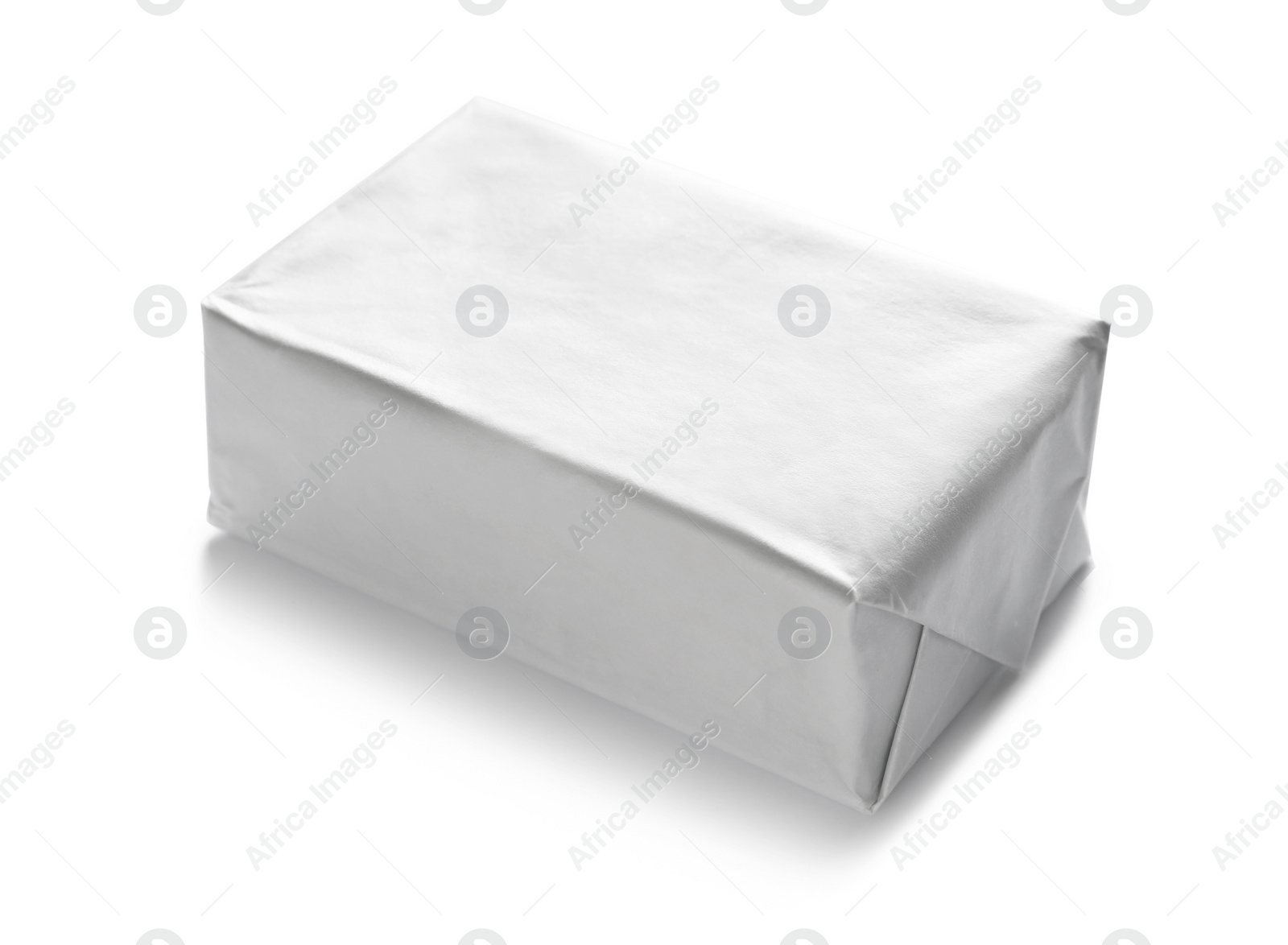 Photo of Block of butter in paper wrapper on white background