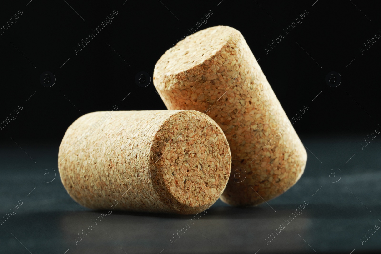 Photo of Corks of wine bottles on grey table, closeup