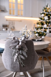 Grey chair with beautiful Christmas decor in kitchen. Interior design