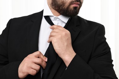 Businessman in suit and necktie indoors, closeup