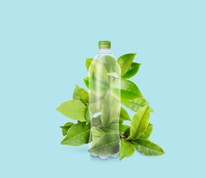 Image of Bottle made of biodegradable plastic and green leaves on light blue background