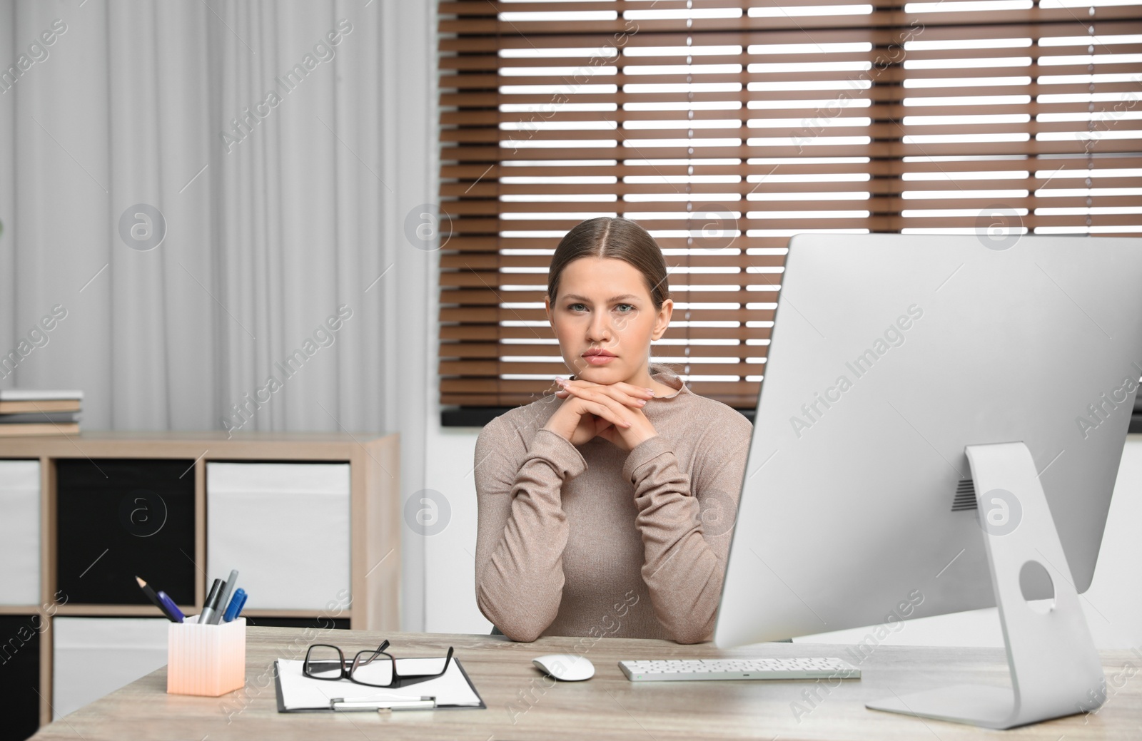 Photo of Professional psychotherapist at table with computer in modern office