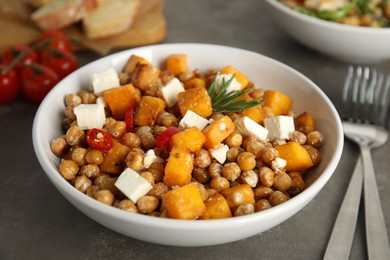 Photo of Delicious fresh chickpea salad on grey table
