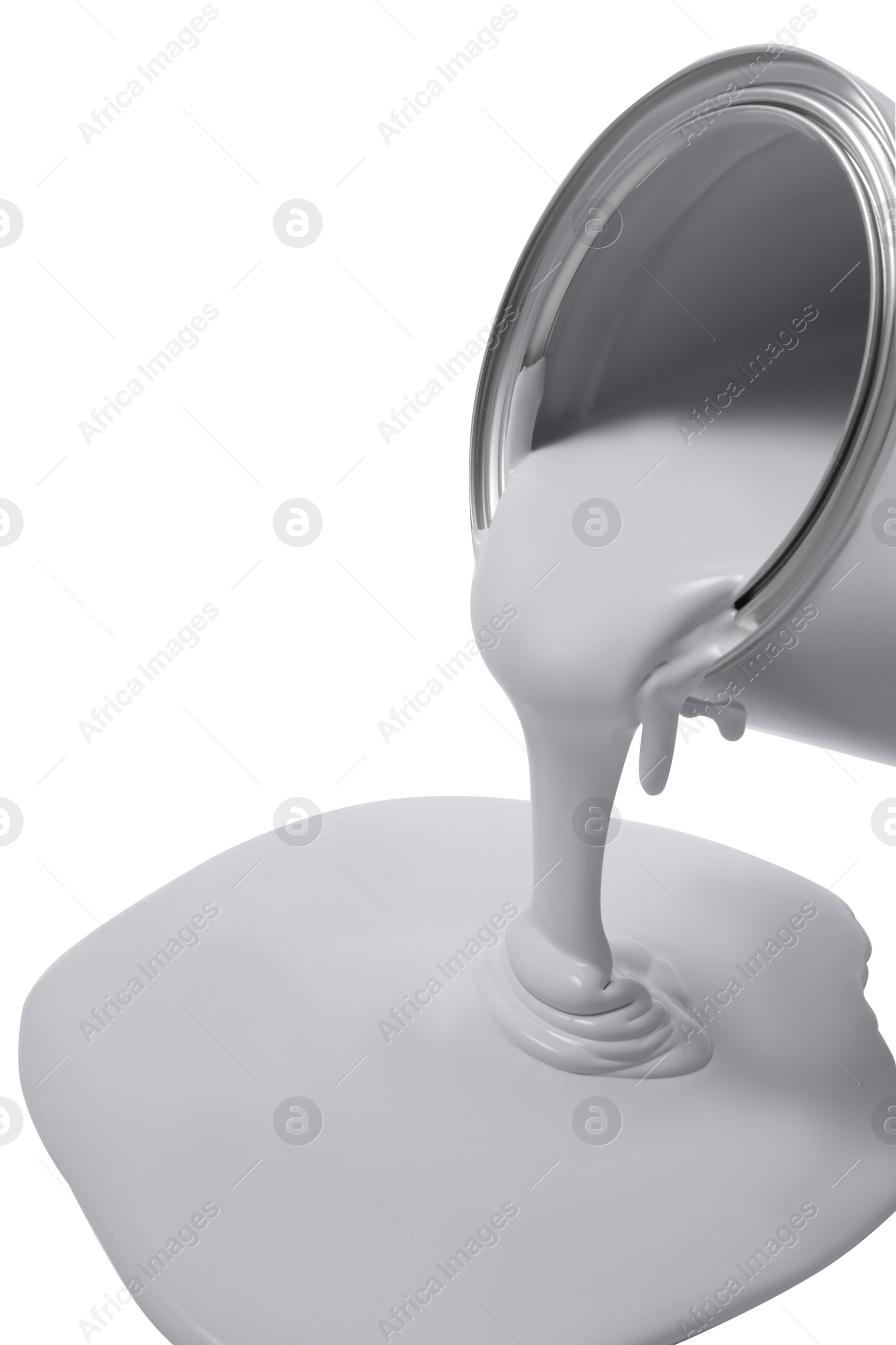 Photo of Pouring paint from can on white background, closeup