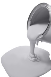 Photo of Pouring paint from can on white background, closeup