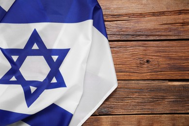 Flag of Israel on wooden background, top view and space for text. National symbol