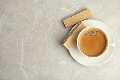 Photo of Breakfast with delicious wafers and coffee on grey marble table, flat lay. Space for text