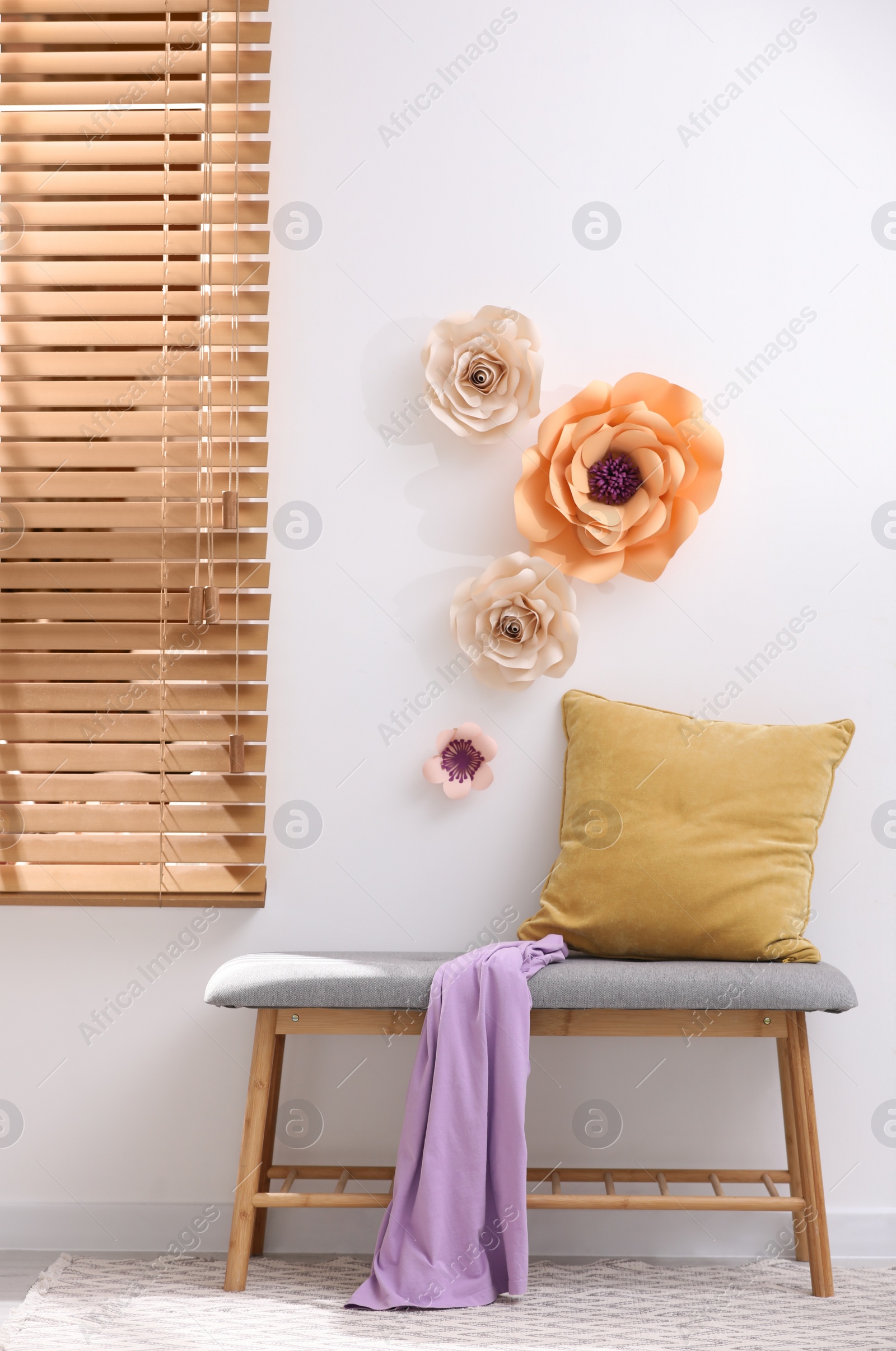 Photo of Stylish room interior with floral decor and comfortable  indoor bench