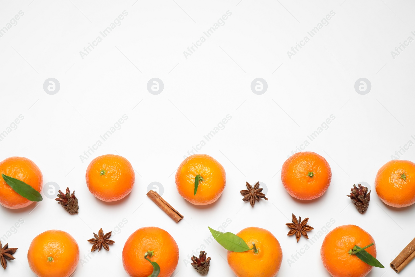 Photo of Christmas composition with tangerines on white background, flat lay. Space for text