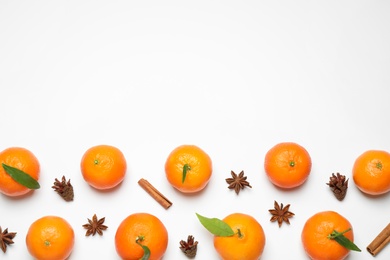 Photo of Christmas composition with tangerines on white background, flat lay. Space for text