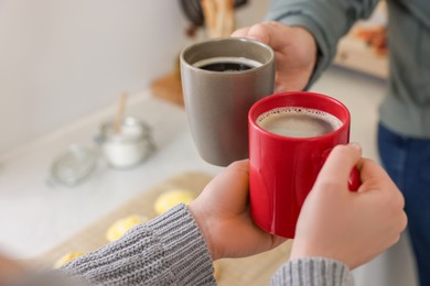 Photo of Couple drinking coffee at home, closeup. Space for text