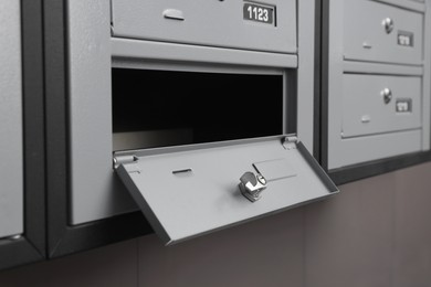 Open empty metal mailbox with keyhole indoors
